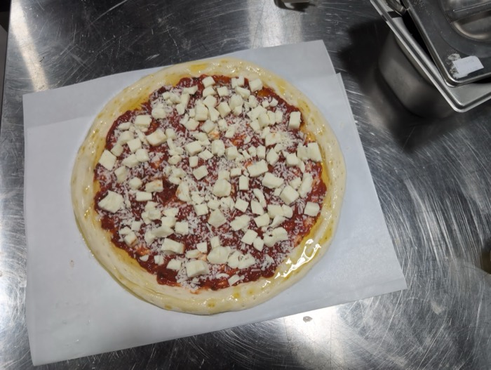 Pizza built and ready for the oven